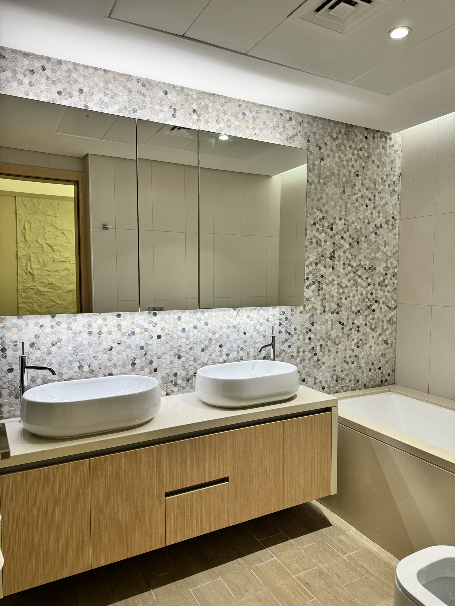 Lisa Villa bathroom with twin countertop basins, a floating vanity and a wide mirror