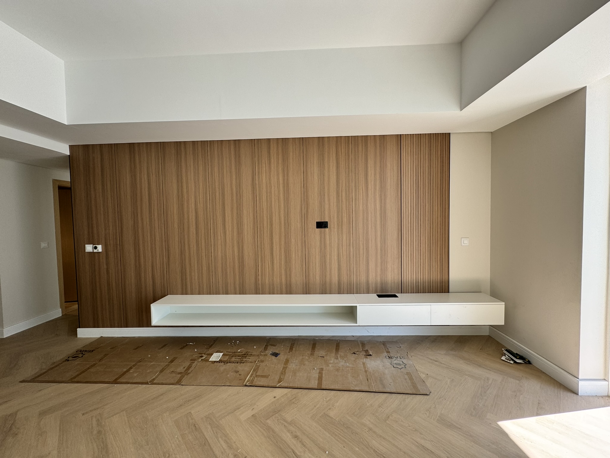 Lisa Villa living room with a wood-grain feature wall and floating white console