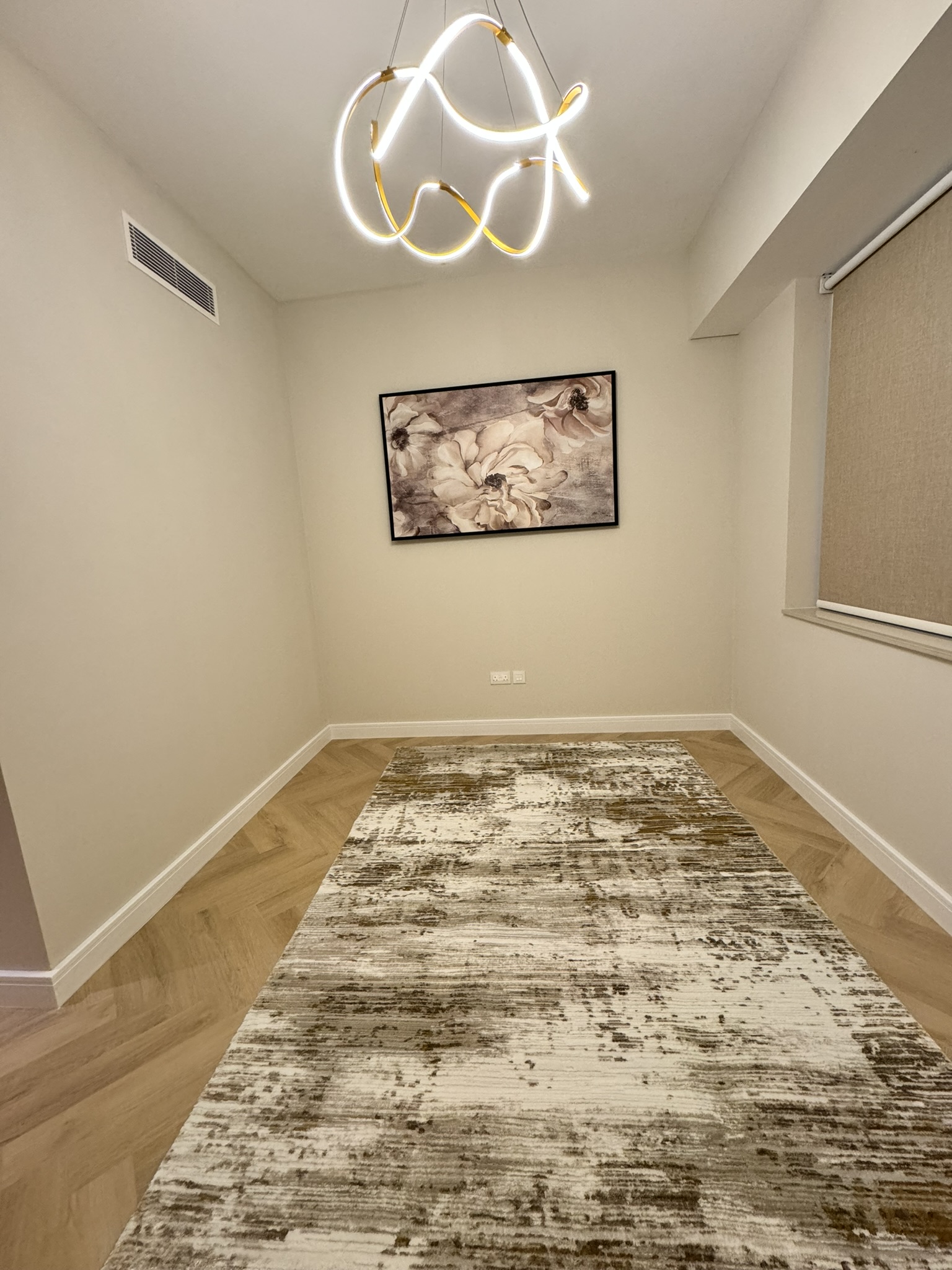 Lisa Villa room with a sculptural pendant, framed artwork, window blinds and a patterned rug