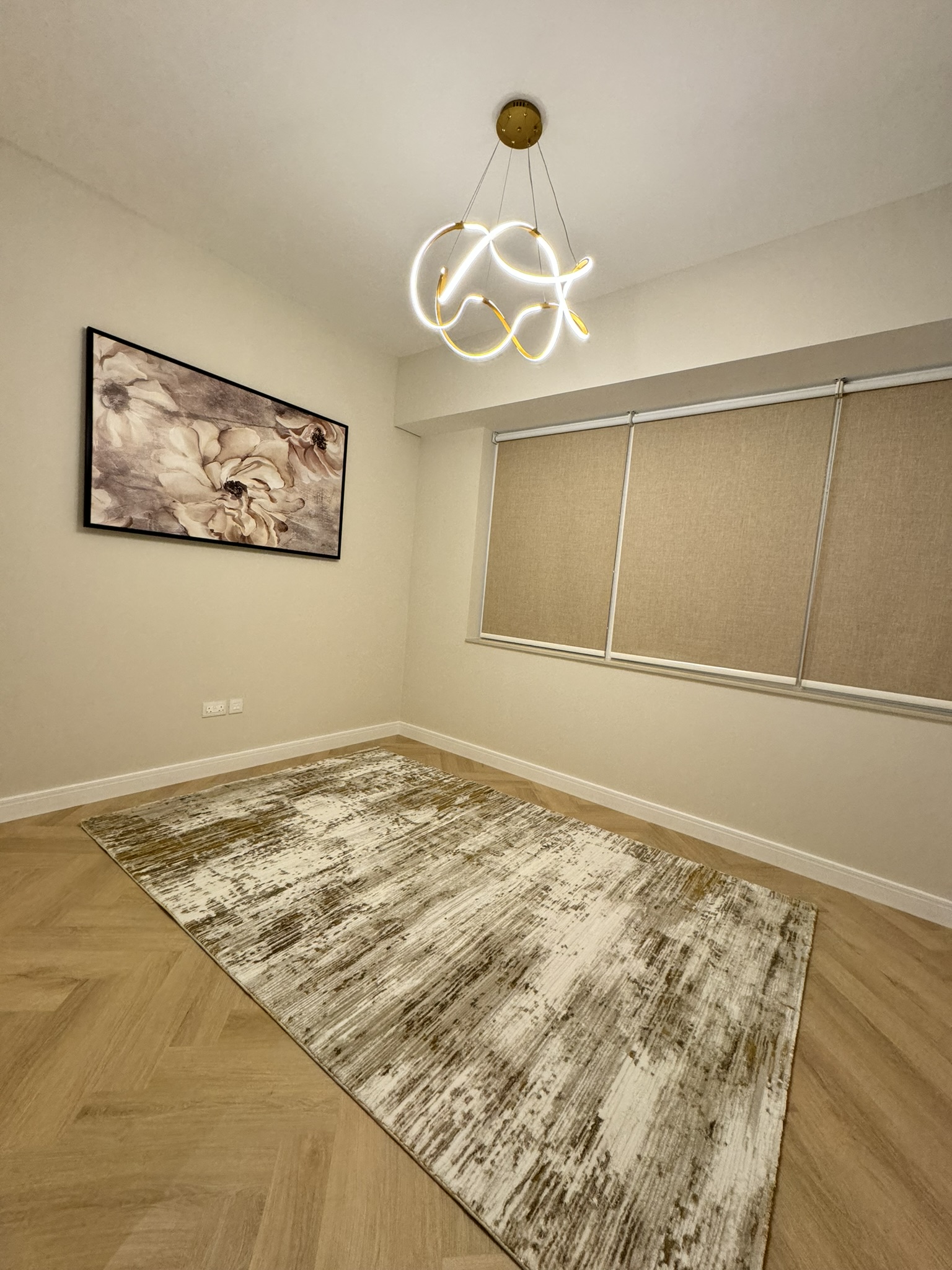 Window blinds, framed artwork and a sculptural ceiling pendant at Lisa Villa