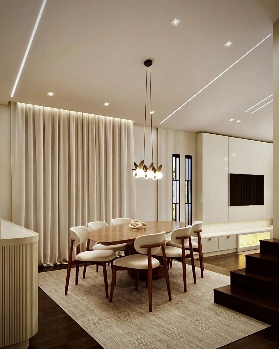 Warm timber, curved seating and a sculptural pendant.
