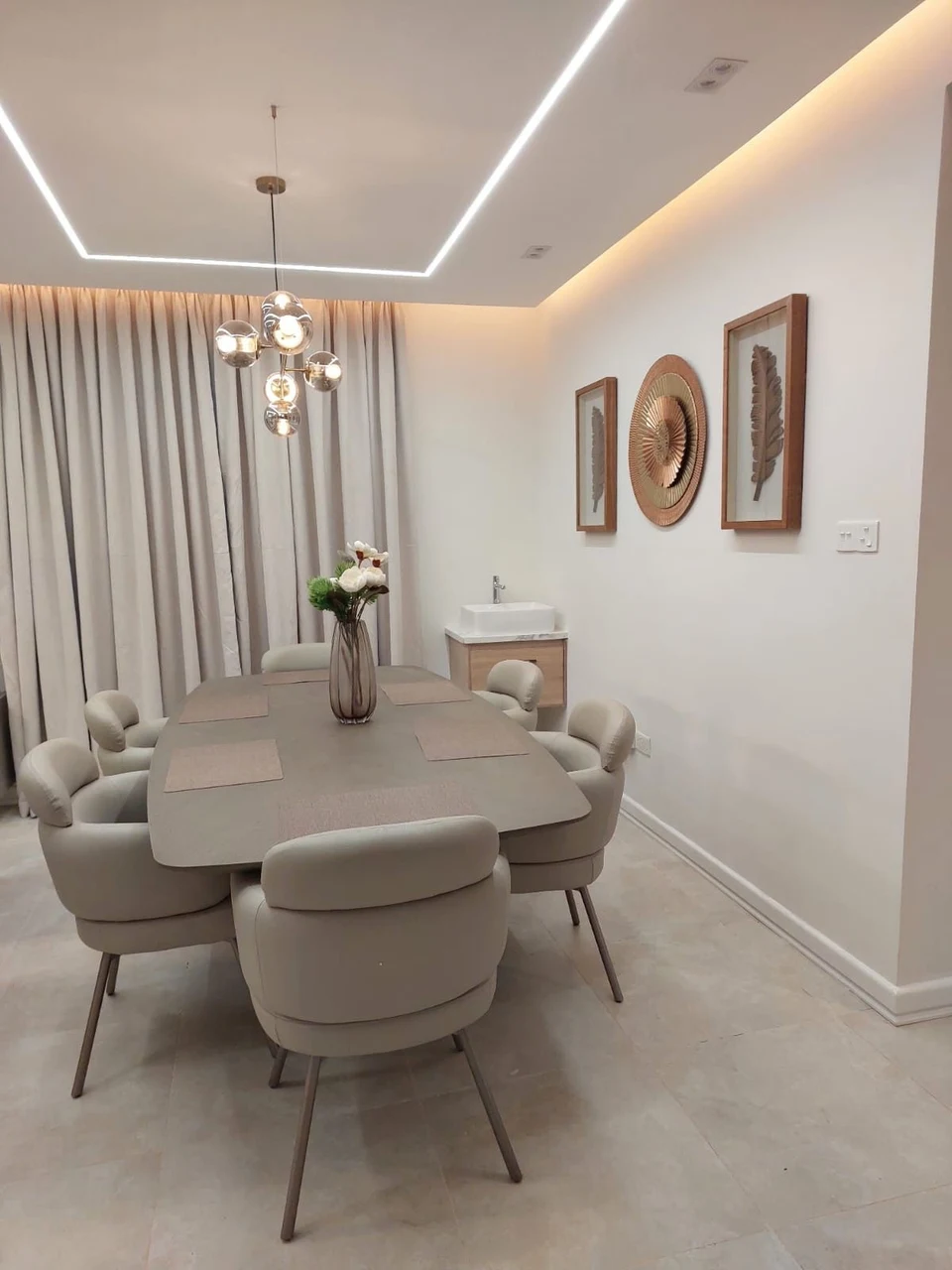 A neutral dining-room reference with pendant and ceiling lighting.